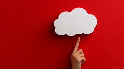 Cloud Computing: A hand points to a white cloud shape against a vibrant red background. This minimal yet powerful image conveys the concept of cloud computing and its boundless potential.
