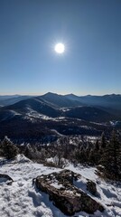 Obraz premium A panoramic photograph from the top, overlooking snow-covered mountains 