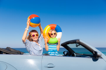 Happy family travel by car by the sea