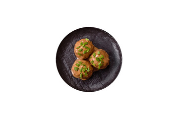 Meatballs with salt and spices in creamy caramel sauce