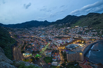 Aerial view of Machico in Portugal island of Madeira, New Year celebration lights all around the town