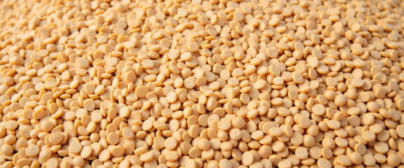Fototapeta premium Close-up of dried yellow lentils background