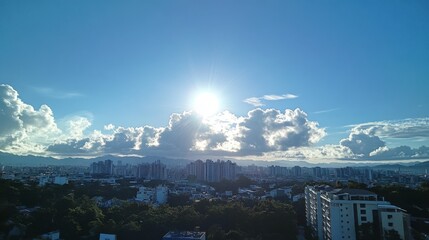 Fototapeta premium The sky is a clear blue color, with a few scattered clouds. The clouds are small and fluffy, and they do not cover the sun. The sun is shining brightly, making it a beautiful day.