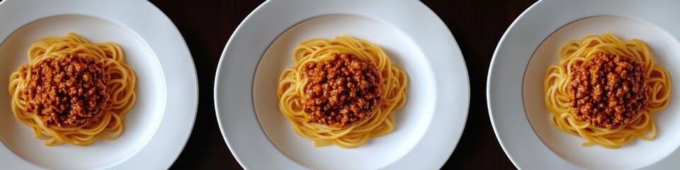 Three plates of spaghetti with tomato sauce