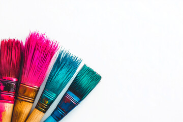 Fototapeta premium Four Paintbrushes with Pink and Teal Bristles on White Background