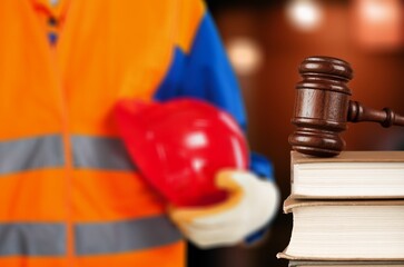 Hammer judge wood gavel with helmet hat on wooden table.