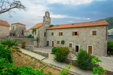 Streets of the old town of Budva with stone walls and cobblestones.