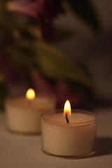 Soft focus. smoke blur Burning Candles in dark. Evening, night Light and shadow beige background. Minimalist still life.