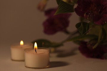 Soft focus. smoke blur Burning Candles in dark. Evening, night Light and shadow beige background. Minimalist still life.