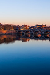 Fototapeta premium Pont Vieux Crossing the Garonne in Toulouse and Notre-Dame de la Dalbade Church at Sunset, Seen from the Opposite Bank