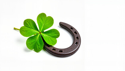 Green clover nestled in horseshoe on white background, symbol of luck