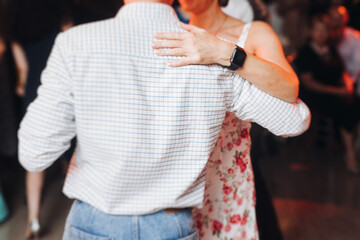 Couples dancing traditional latin argentinian dance milonga in the ballroom, tango salsa bachata...
