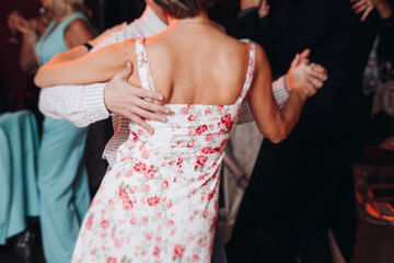 Couples dancing traditional latin argentinian dance milonga in the ballroom, tango salsa bachata...