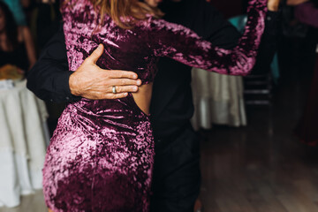 Couples dancing traditional latin argentinian dance milonga in the ballroom, tango salsa bachata...