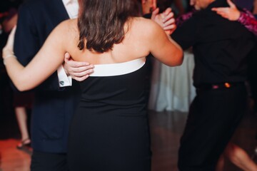 Couples dancing traditional latin argentinian dance milonga in the ballroom, tango salsa bachata kizomba lesson in red and purple lights, performance rehearsal, evening dance school class festival