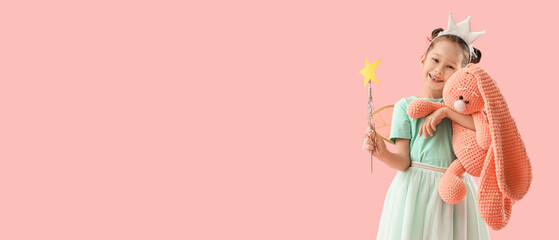 Cute little fairy with wand with toy bunny on pink background