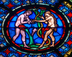 Stained glass (19th century) of Adam and Eve in paradise tempted by the snake. .
