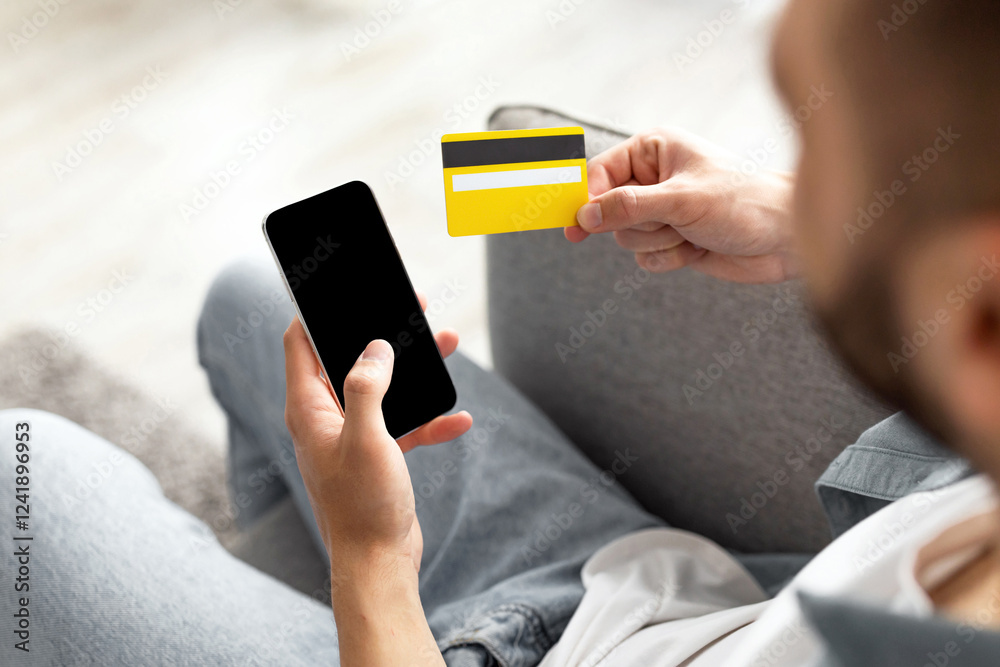 Poster ordering goods online. unrecognizable young guy with credit card and smartphone shopping on web at h