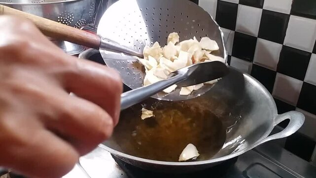 Process Deep Frying Crackers in the Hot Oil, Kitchen Step by Step. Goreng Kerupuk, Indonesian Crackers