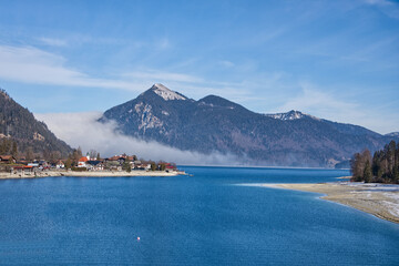 Mountain landscape with frozen lake and forest in the winter