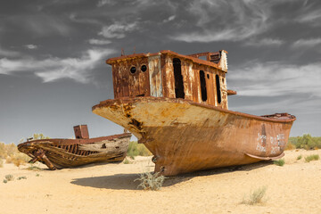 Rusting shipwrecks on what used to be the seabed of the Aral Sea. The Aral Sea has lost significant amounts of water coverage due to excessive irrigation. Moynaq, Uzbekistan