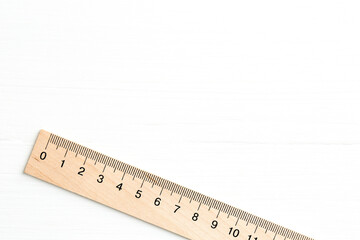 One ruler on white wooden table, top view. Space for text