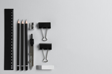 Flat lay composition with ruler and other stationery on light grey background, space for text