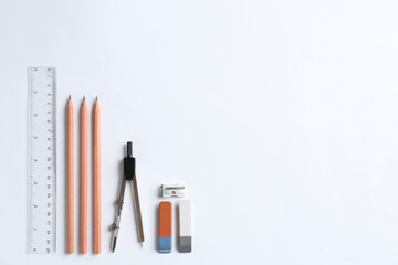 Flat lay composition with ruler and other stationery on white background, space for text