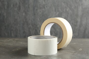 Rolls of masking tapes on grey table, closeup