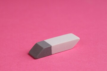 One eraser on pink background, closeup view