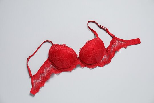 Beautiful red bra on light background, top view