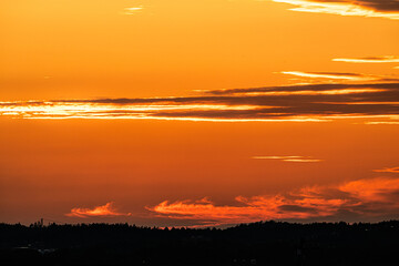 golden sunset over the horizon with vibrant clouds.