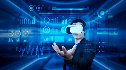 Project manager with VR goggles holding financial chart and glowing blue light at office. Skilled businessman checking and planning marketing strategy by using data from augmented reality. Ingenuity.