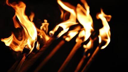 Fototapeta premium Flames dancing on matchsticks in a dark space