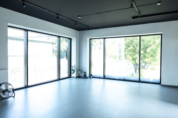 Fototapeta premium Modern apartment with big windows empty interior space designed in minimalism