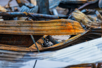 pile of twisted rusted metal debris from collapsed structure.