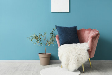 Beautiful living room with pink armchair, plaid and pillow