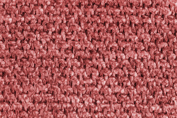 Texture of red jacquard fabric, close up of rough weave macro. Material for home textile, upholstery and curtain decor, garment. Background, wallpaper, backdrop.
