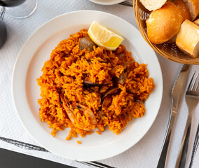 Delicious traditional Valencian seafood paella - savory rice dish with shrimps and clams. High quality photo