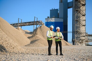 Two engineers at an industrial plant. Crushed stone production plant. Gravel