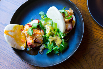 Baozi with sliced octopus tentacles with piquant Indian mango and bacon chutney and greens