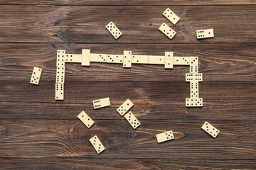 Many white dominos blocks on wooden background