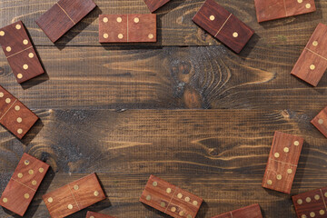 Frame made of many dominos blocks on wooden background