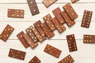 Many dominos blocks on white wooden background