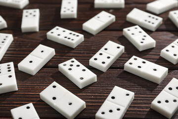 Many white dominos blocks on dark wooden background