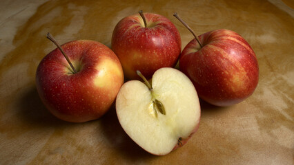 Group of sliced Gala apples and green apples on a wooden table