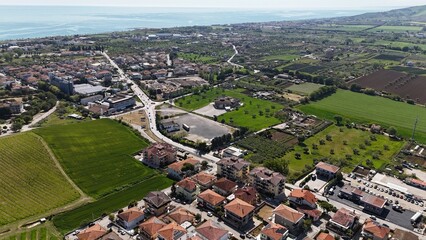 Aerial photo of houses, roofs, streets and greenery in the Italian town of Roseto degli Abruzzi.