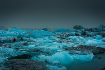 Floating iceberg of the Jokulsarlon Glacier Lagoon under heavy rain with the fog,  Iceland