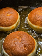 Photo of doughnuts fried in oil. Delicious.