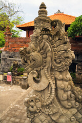 A detailed stone sculpture of a mythical creature in Bali, showcasing intricate carvings and...